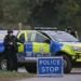 Police and security forces near RAF Fairford airbase in Gloucestershire after five men were arrested