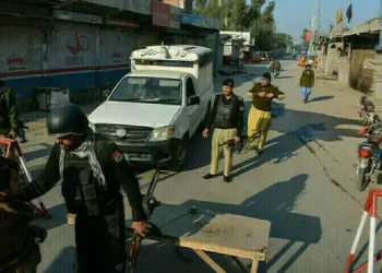 Police personnel at the scene of a traffic police vehicle attack in Tank district