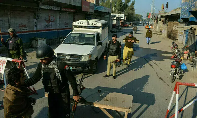 Police personnel at the scene of a traffic police vehicle attack in Tank district