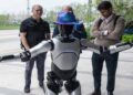 Foreign investors visiting a Chinese factory showcasing robotics and advanced manufacturing technology