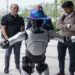 Foreign investors visiting a Chinese factory showcasing robotics and advanced manufacturing technology