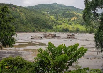 Rescue teams searching for survivors after a flood and landslide in Nepal