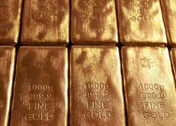 Gold bullion and market charts as investors monitor US inflation and Federal Reserve rate expectations.