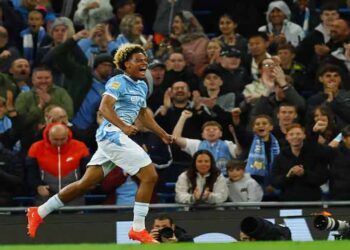 Floyd Samba celebrates scoring for Manchester City against Norwich City.