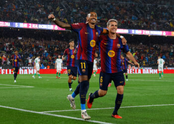 Raphinha celebrates his hat-trick during Barcelona’s 7-2 win over Racing Santander.