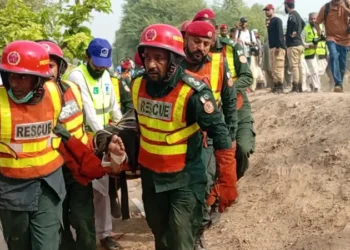 Rescue workers assist passengers following the Rehman Baba Express derailment near Multan.