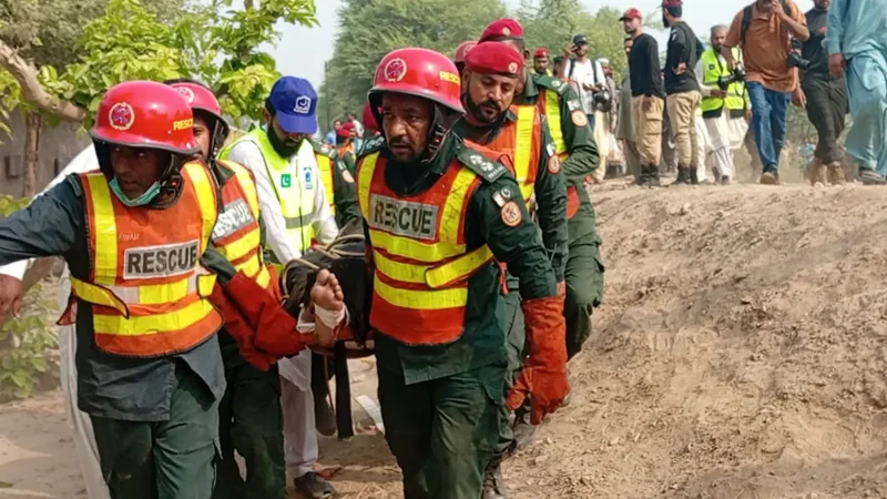Rescue workers assist passengers following the Rehman Baba Express derailment near Multan.