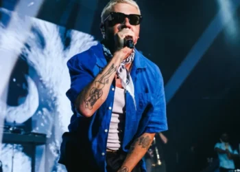 Macklemore performing on stage at Red Rocks Amphitheatre while expressing support for Palestine and criticising ICE.