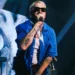 Macklemore performing on stage at Red Rocks Amphitheatre while expressing support for Palestine and criticising ICE.