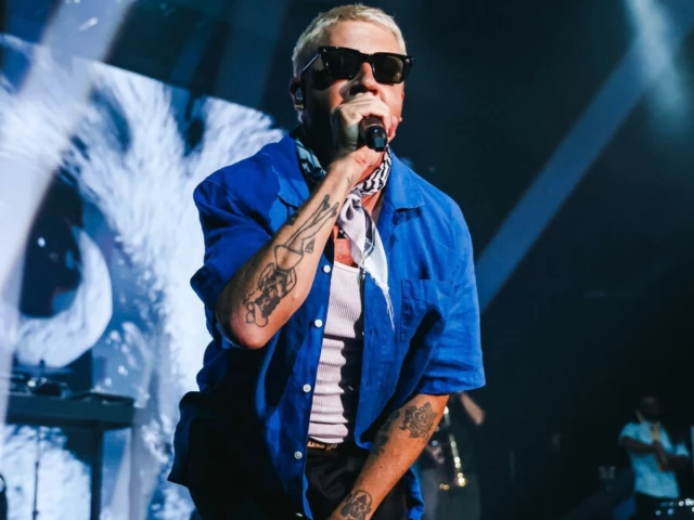 Macklemore performing on stage at Red Rocks Amphitheatre while expressing support for Palestine and criticising ICE.