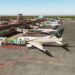 Passenger aircraft at an airport amid flight cancellations and delays affecting Pakistan and Saudi Arabia.