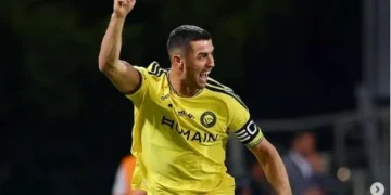 Cristiano Ronaldo of Al Nassr celebrates during a match against Al Faisaly amid controversy over the official credit for his 982nd career goal.