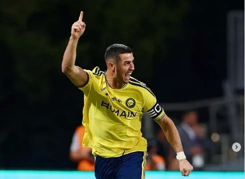 Cristiano Ronaldo of Al Nassr celebrates during a match against Al Faisaly amid controversy over the official credit for his 982nd career goal.