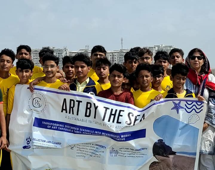 Students collecting litter and discarded seashells during a beach cleanup drive at Seaview, Karachi.