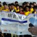 Students collecting litter and discarded seashells during a beach cleanup drive at Seaview, Karachi.
