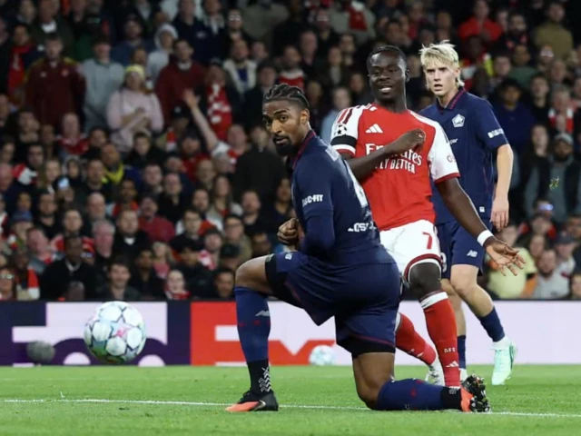 Arsenal players celebrate after scoring against Lille during their Champions League match in London.