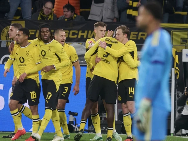 Borussia Dortmund players celebrate Maximilian Beier’s late winning goal against Eintracht Frankfurt in the Bundesliga.