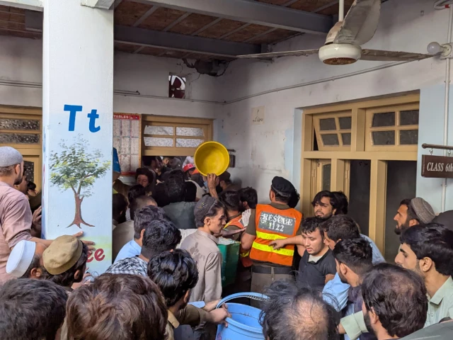 Rescue personnel search through debris after a private school roof collapses in Peshawar, injuring children and killing students and teachers.